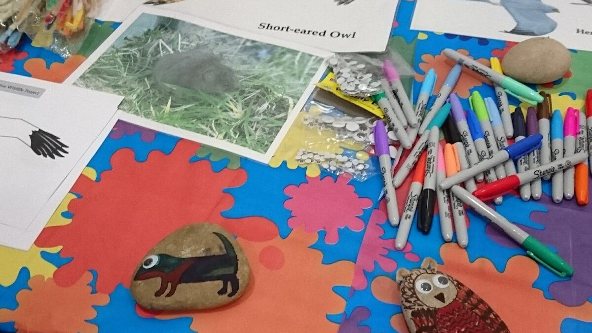 Pens and drawings on a bright table cloth